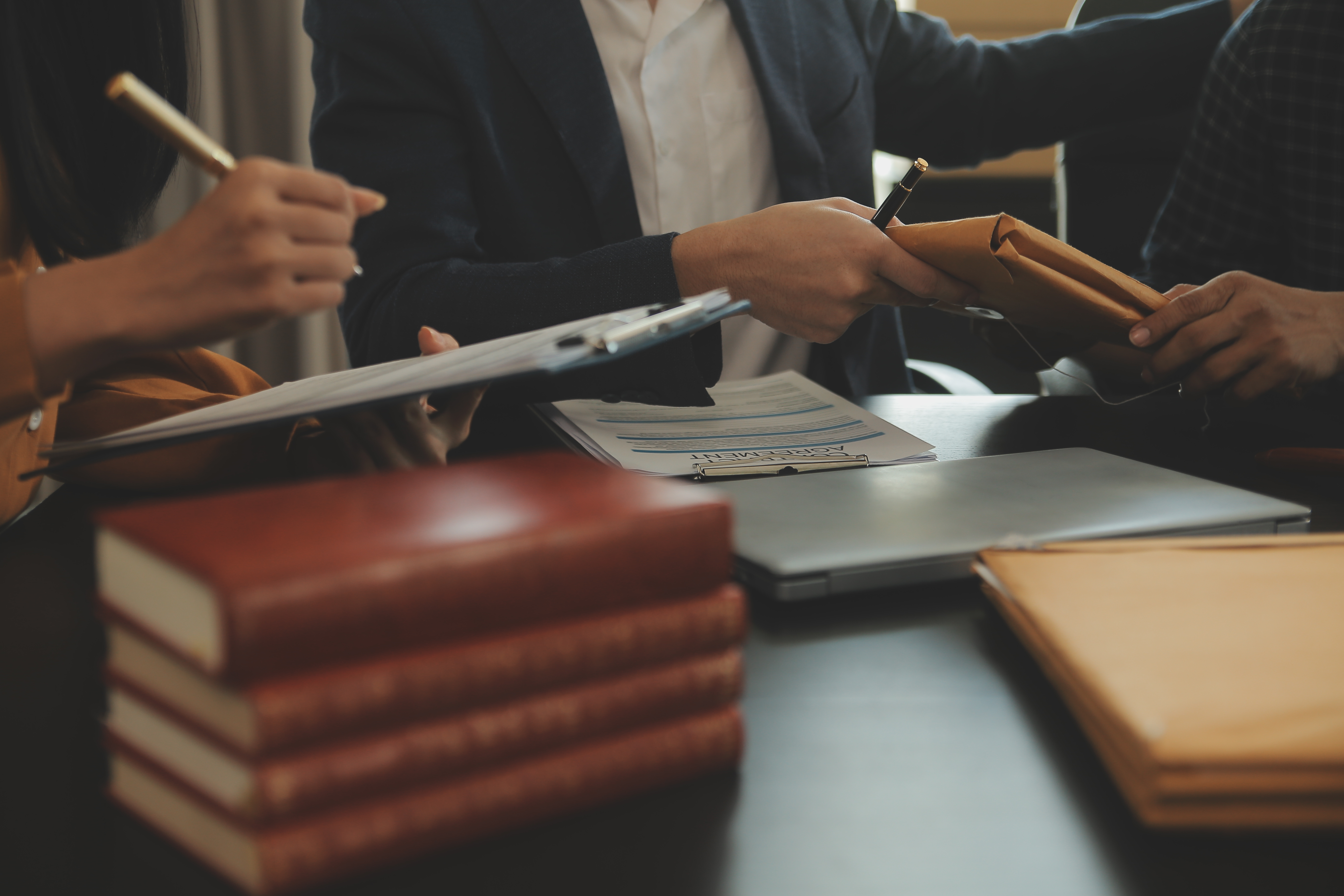 justice-law-concept-legal-counsel-presents-client-signed-contract-with-gavel-legal-law-legal-having-team-meeting-law-firm-background.jpg